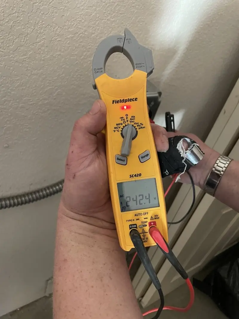 Voltage testing with clamp meter during Recessed Lighting Installation in Alton
